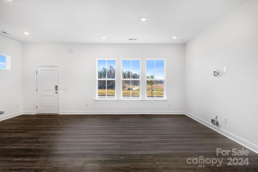 1156 Lost Cv Road Indian Land, SC 29707 - Photo 6 of 19 a view of an empty room with wooden floor and a window