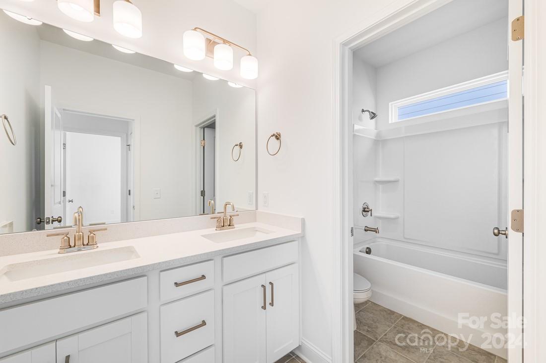 1156 Lost Cv Road Indian Land, SC 29707 - Photo 9 of 19 a bathroom with a tub a sink and mirror