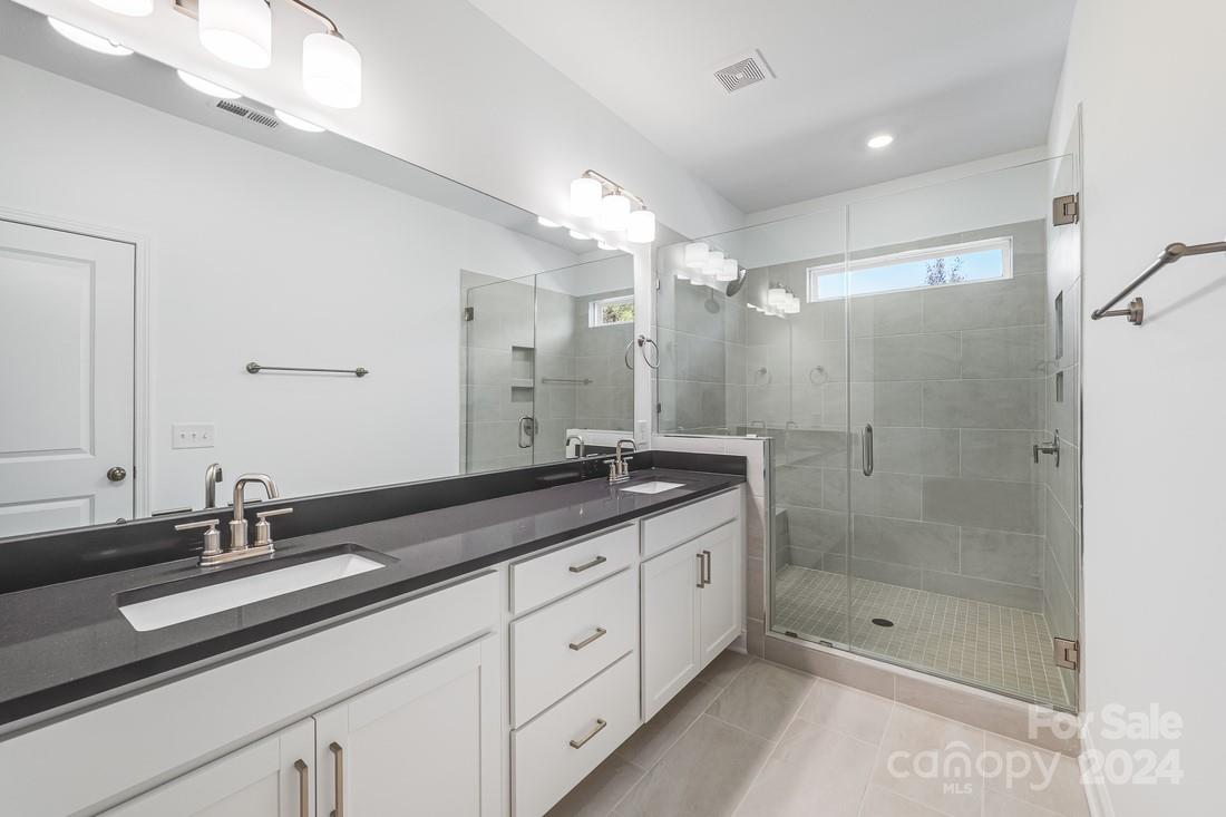 1156 Lost Cv Road Indian Land, SC 29707 - Photo 10 of 19 a bathroom with a shower sink double and mirror