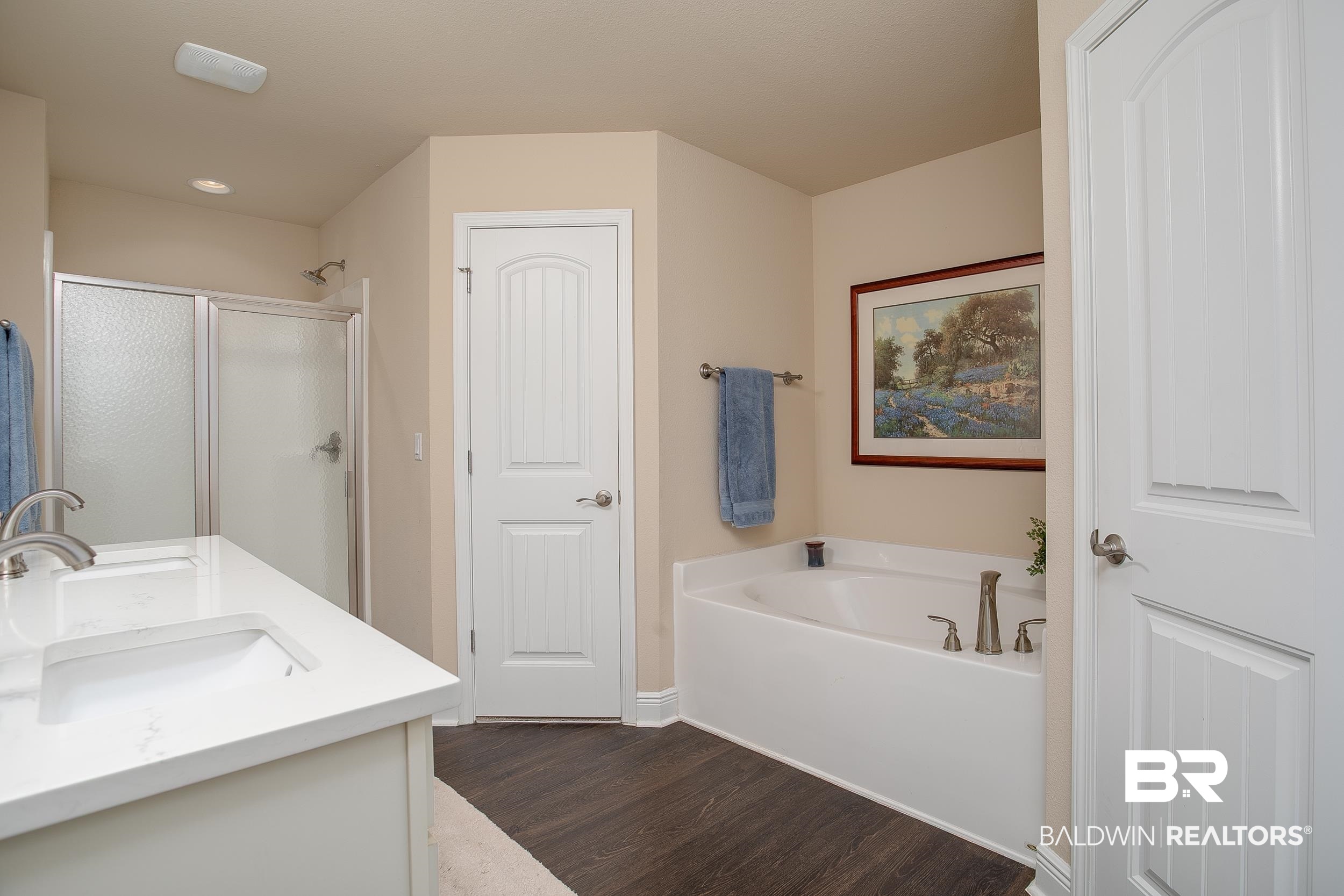 13154 Vincent Court Foley, AL 36535 - Photo 16 of 41 Bathroom with wood finished floors, a shower stall, a sink, double vanity, and a bath
