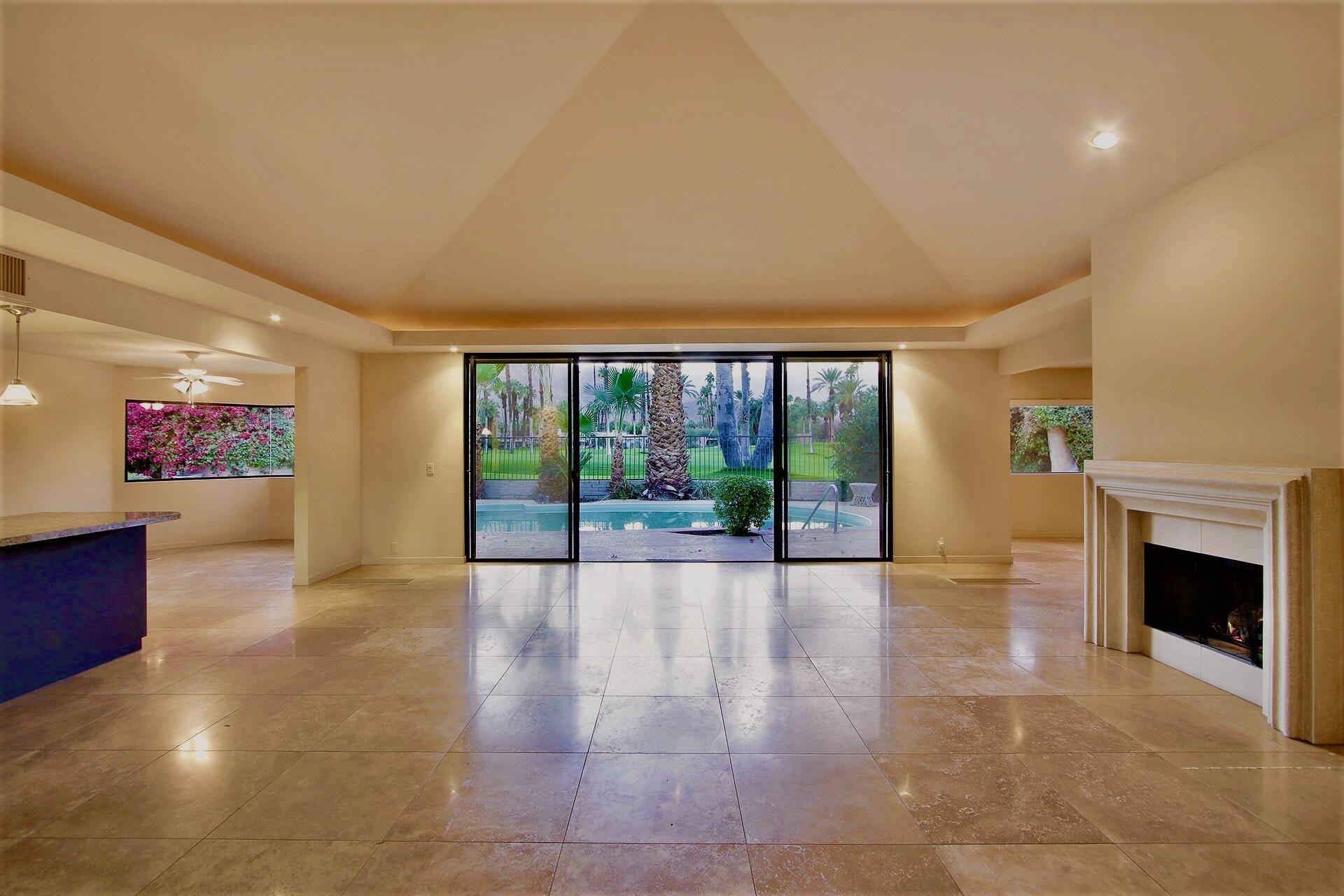 40281 Sand Dune Road Rancho Mirage, CA 92270 - Photo 12 of 41 a view of an empty room with a fireplace and a large window