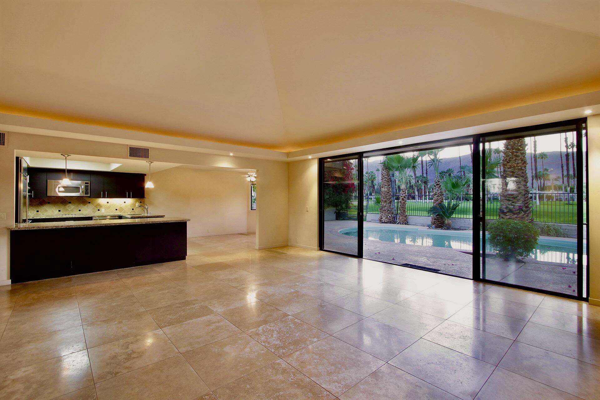40281 Sand Dune Road Rancho Mirage, CA 92270 - Photo 13 of 41 a living room with furniture and a floor to ceiling window