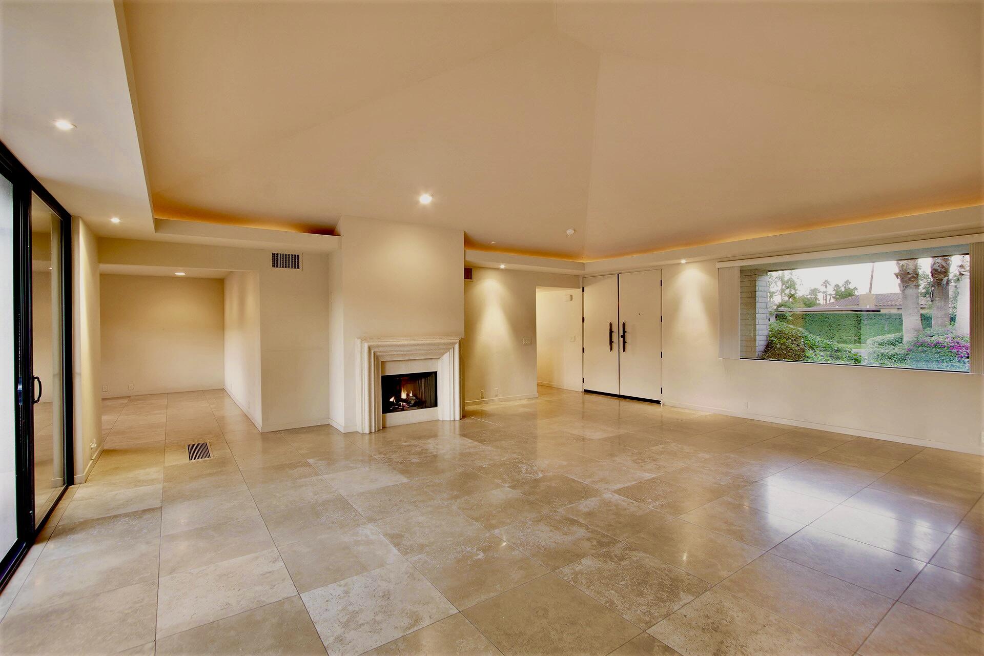 40281 Sand Dune Road Rancho Mirage, CA 92270 - Photo 15 of 41 a view of an empty room with a fireplace and a window