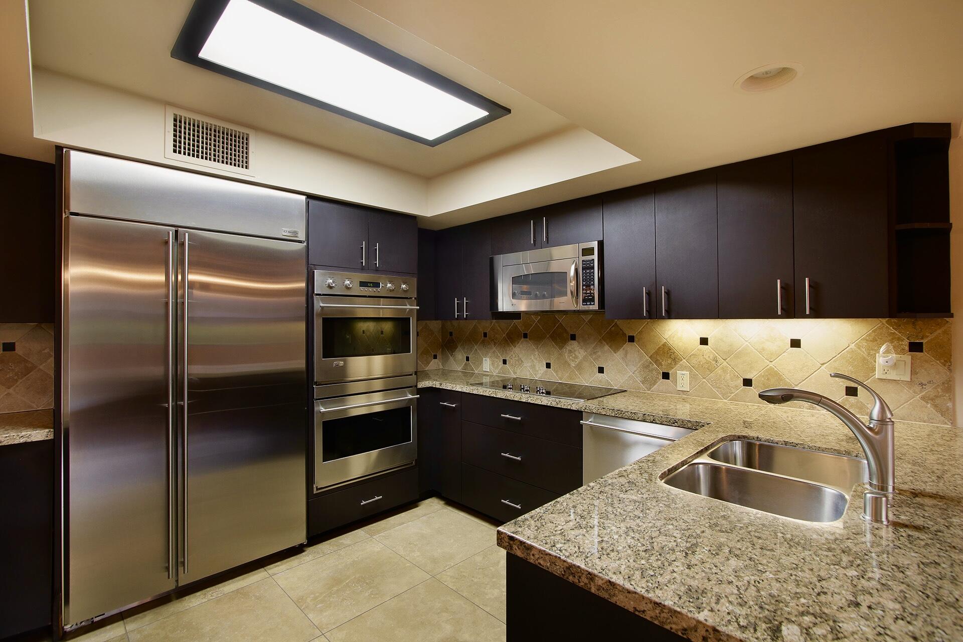 40281 Sand Dune Road Rancho Mirage, CA 92270 - Photo 18 of 41 a kitchen with granite countertop a refrigerator and a sink