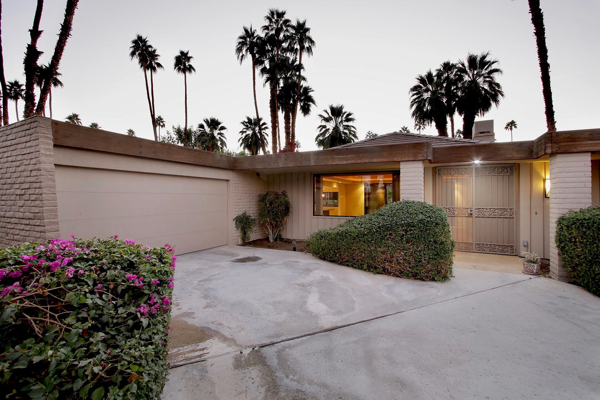 40281 Sand Dune Road Rancho Mirage, CA 92270 - Photo 2 of 41 a front view of a house with a yard and potted plants