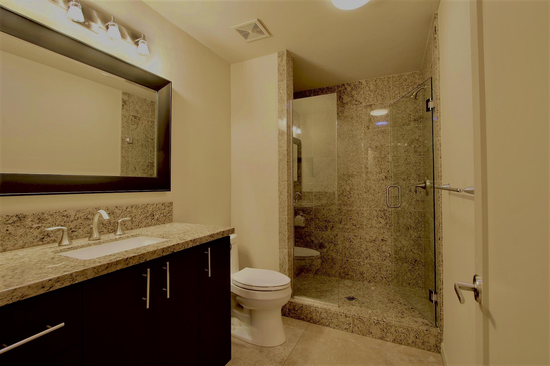 40281 Sand Dune Road Rancho Mirage, CA 92270 - Photo 27 of 41 a bathroom with a shower sink vanity mirror and toilet