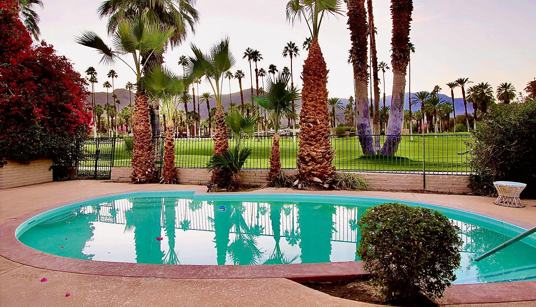 40281 Sand Dune Road Rancho Mirage, CA 92270 - Photo 40 of 41 a view of a swimming pool with a garden and trees