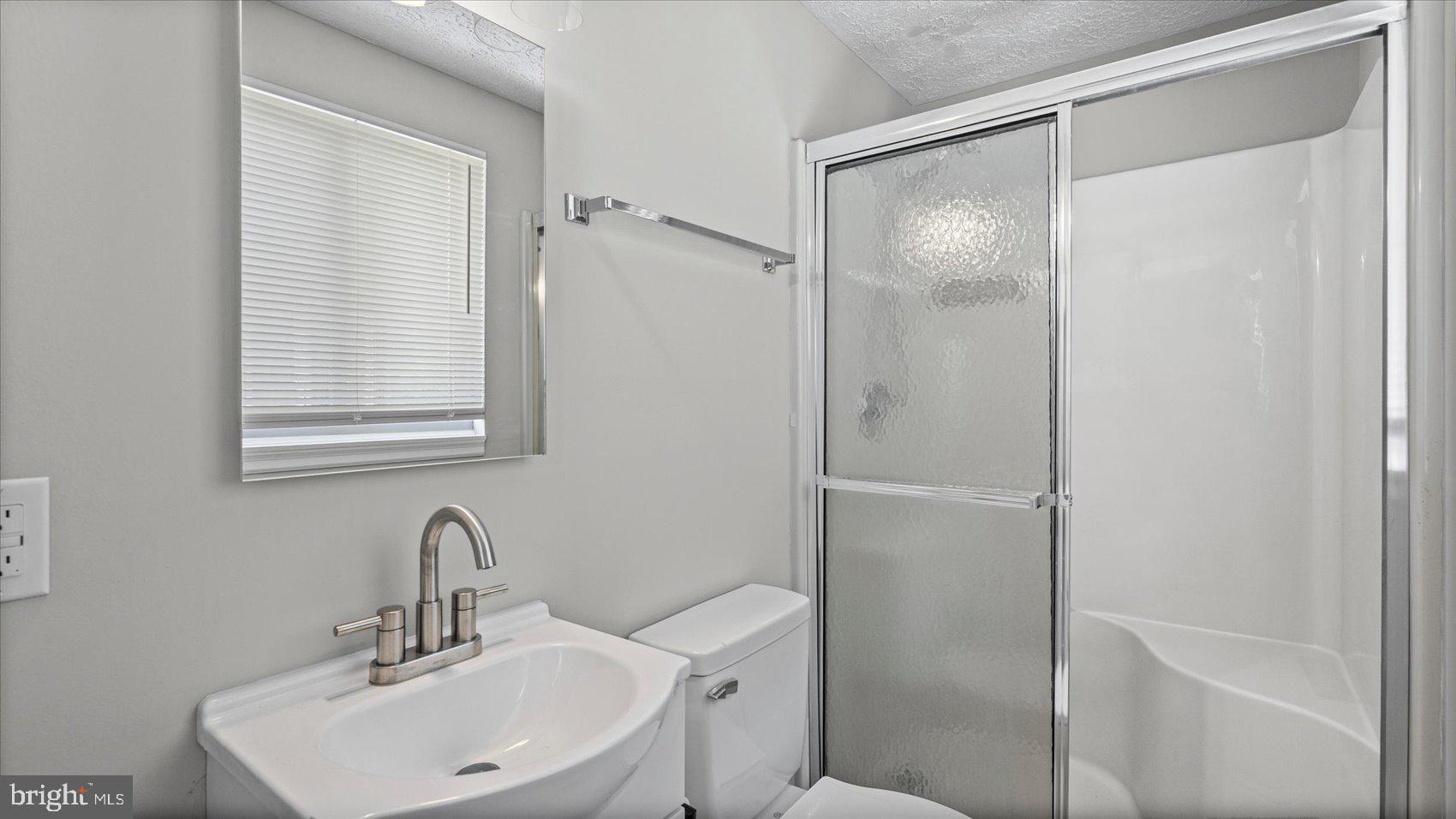 3709 Redberry Way Nottingham, MD 21236 - Photo 21 of 45 a bathroom with a shower sink vanity and mirror