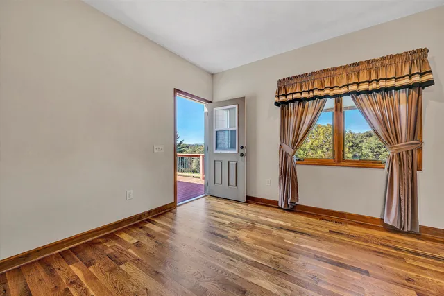 a view of room with wooden floor and a window