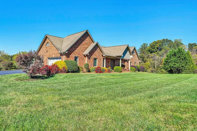 a view of a hallway with wooden floor and a rug