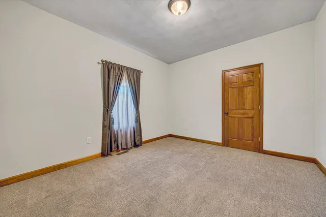 a kitchen with stainless steel appliances granite countertop a refrigerator a sink and white cabinets