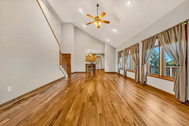 a view of a hallway with wooden floor and entryway