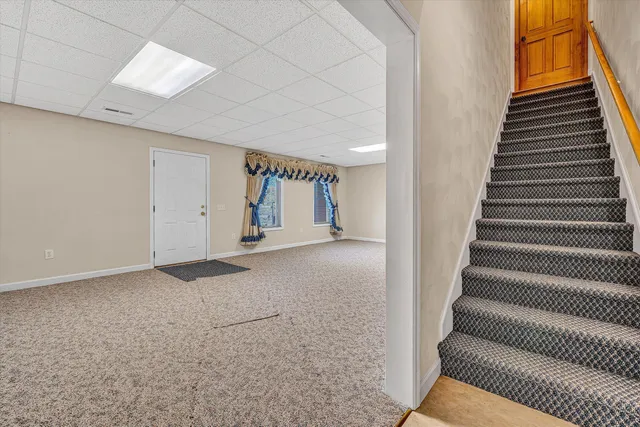 a front view of a house with yard and green space