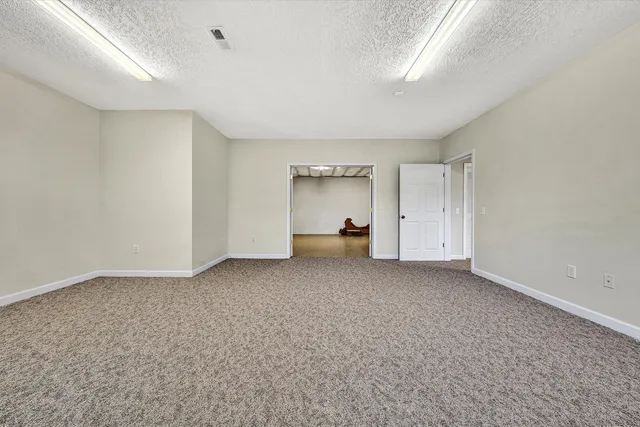 an aerial view of a house with yard and green space