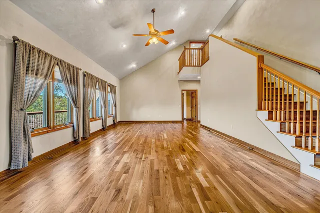 a view of balcony with wooden floor and fence