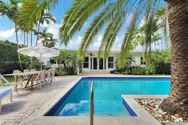 a view of a patio with couches and a fire pit