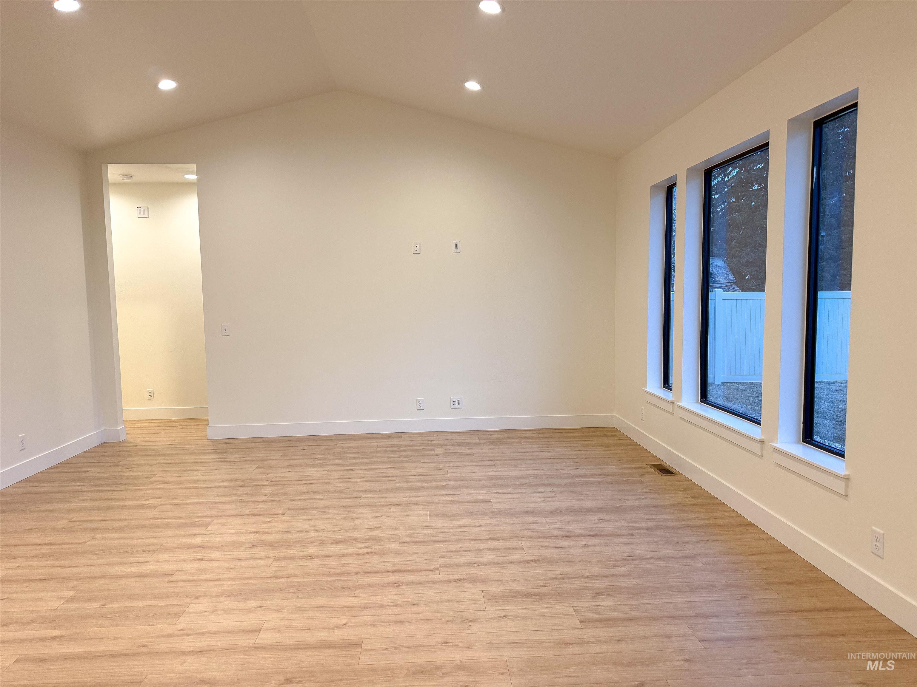 245 Whitman Street Albion, ID 83311 - Photo 5 of 15 Empty room featuring recessed lighting, light wood finished floors, and vaulted ceiling