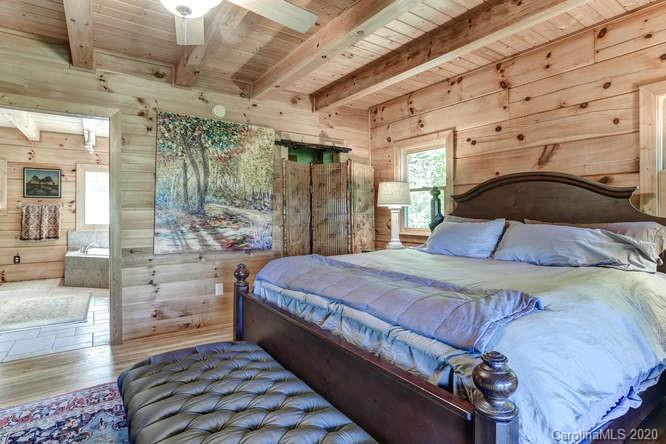 110 Cornerstone Ridge Waynesville, NC 28786 - Photo 22 of 33 a bed sitting in a bedroom next to a larger window