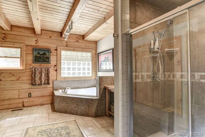 110 Cornerstone Ridge Waynesville, NC 28786 - Photo 23 of 33 a bathroom with a tub shower and window