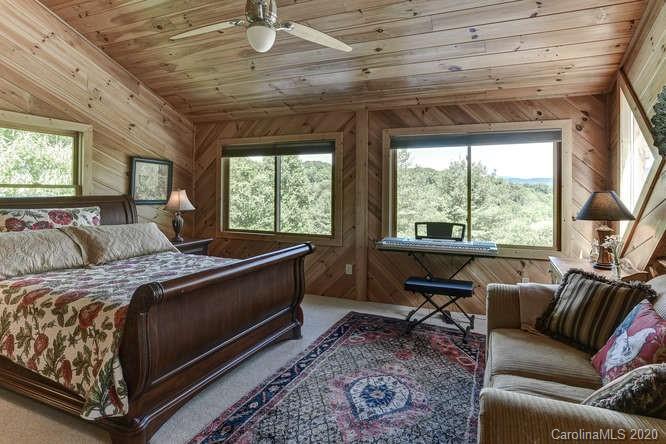 110 Cornerstone Ridge Waynesville, NC 28786 - Photo 27 of 33 a bed sitting in a bedroom next to a window