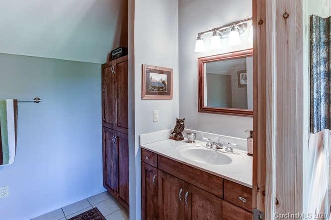 110 Cornerstone Ridge Waynesville, NC 28786 - Photo 30 of 33 a bathroom with a sink vanity and mirror