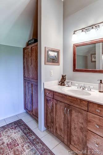 110 Cornerstone Ridge Waynesville, NC 28786 - Photo 33 of 33 a bathroom with a granite countertop sink and a mirror