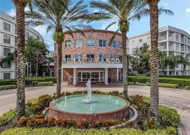 a front view of a house with a yard and potted plants