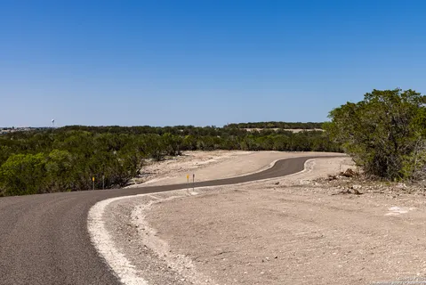 a view of a dry yard with a lake view