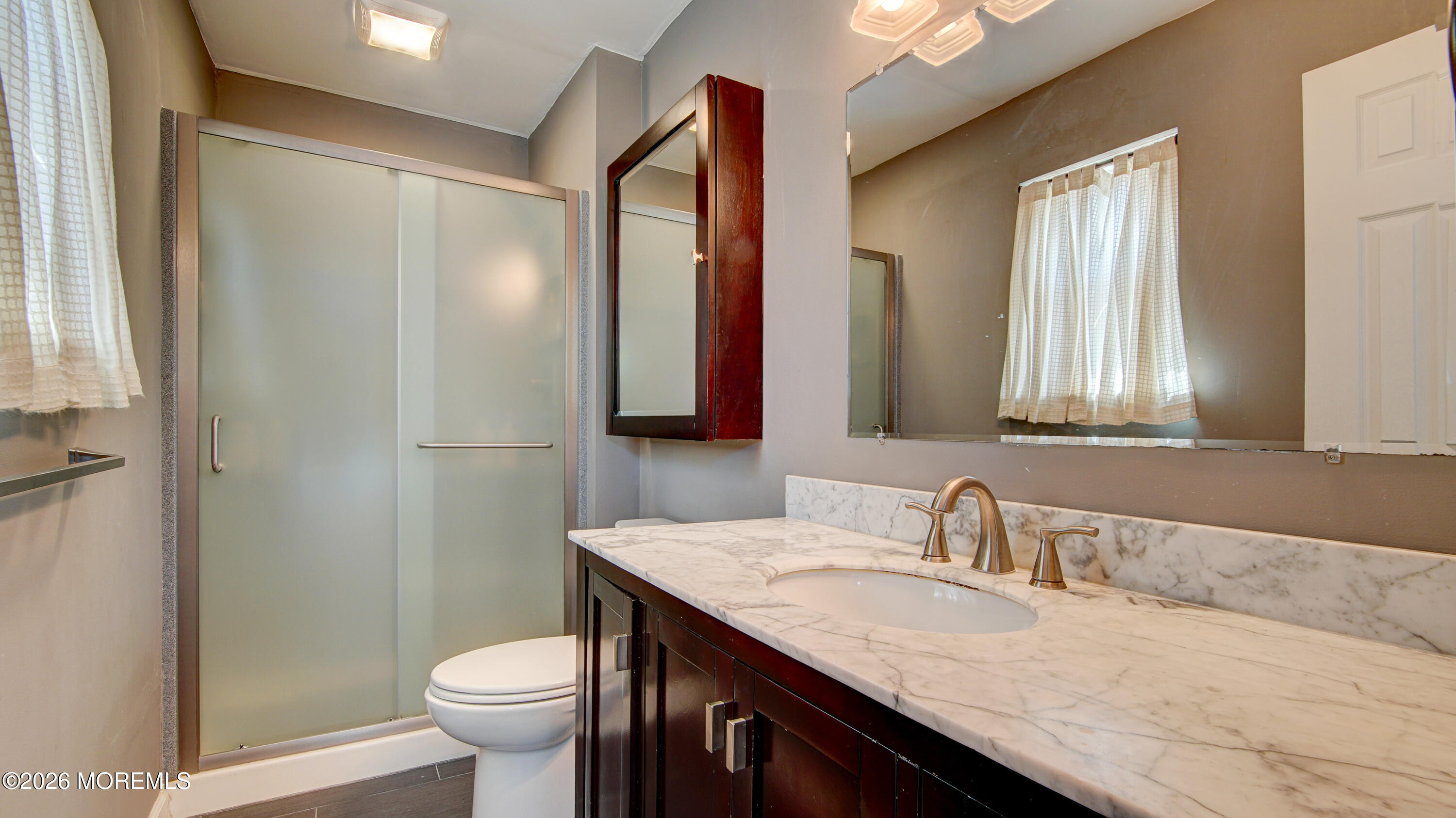 128 Starlight Road Howell, NJ 07731 - Photo 21 of 36 a bathroom with a granite countertop sink toilet and mirror
