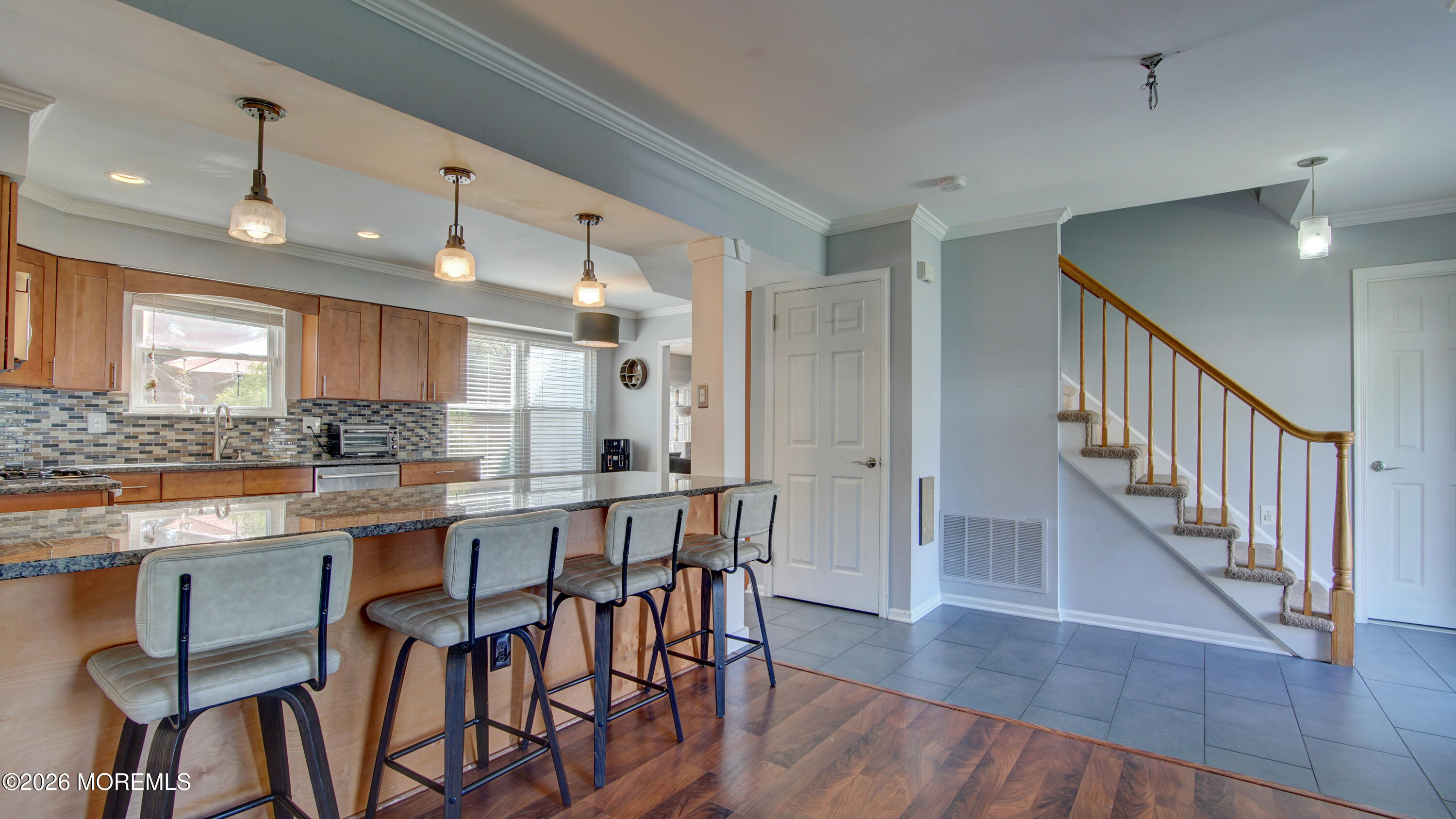 128 Starlight Road Howell, NJ 07731 - Photo 5 of 36 a kitchen with stainless steel appliances kitchen island a table and chairs in it