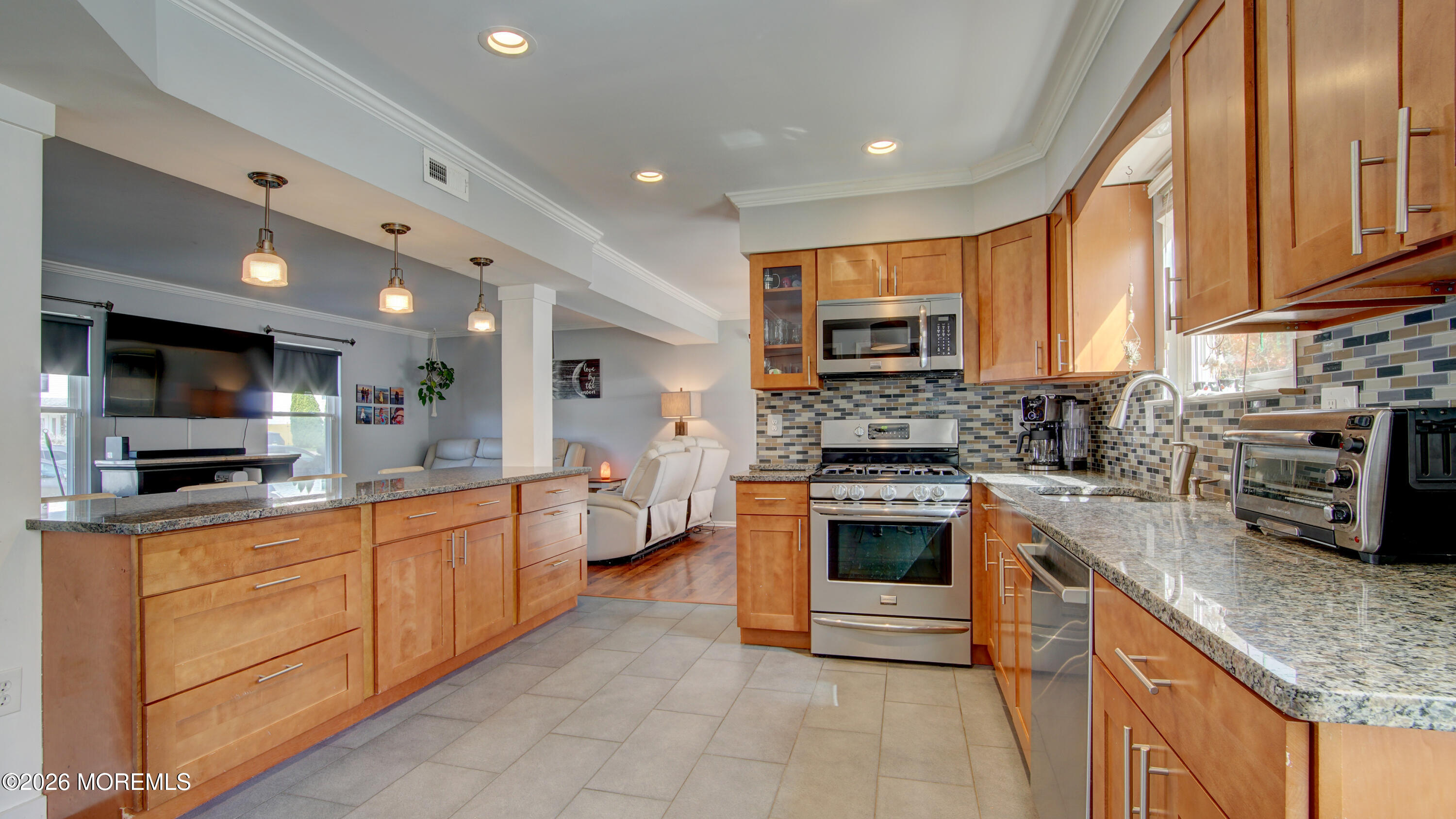 128 Starlight Road Howell, NJ 07731 - Photo 8 of 36 a large kitchen with stainless steel appliances granite countertop a stove and a sink