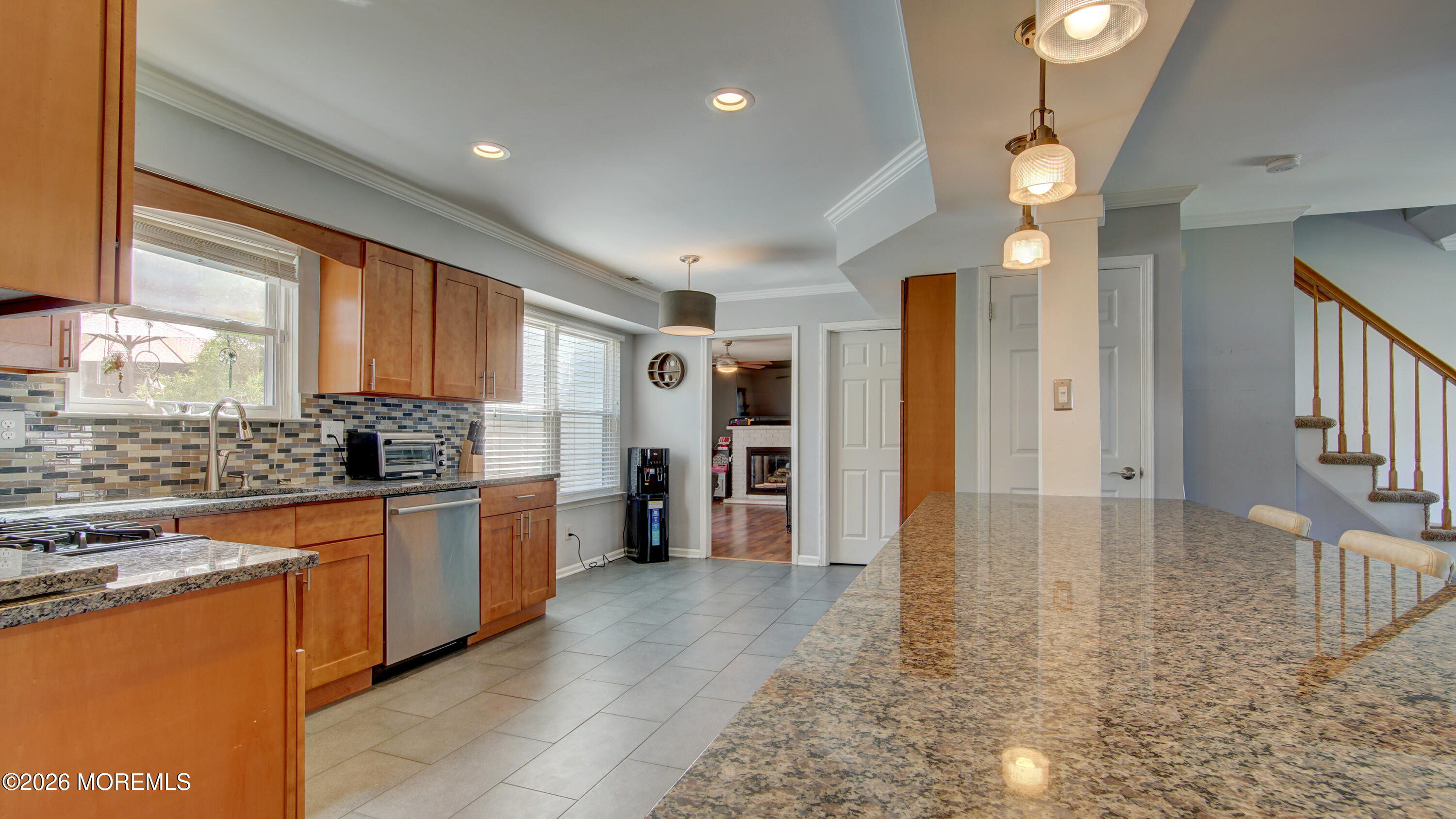 128 Starlight Road Howell, NJ 07731 - Photo 10 of 36 a large kitchen with granite countertop a stove refrigerator and a sink