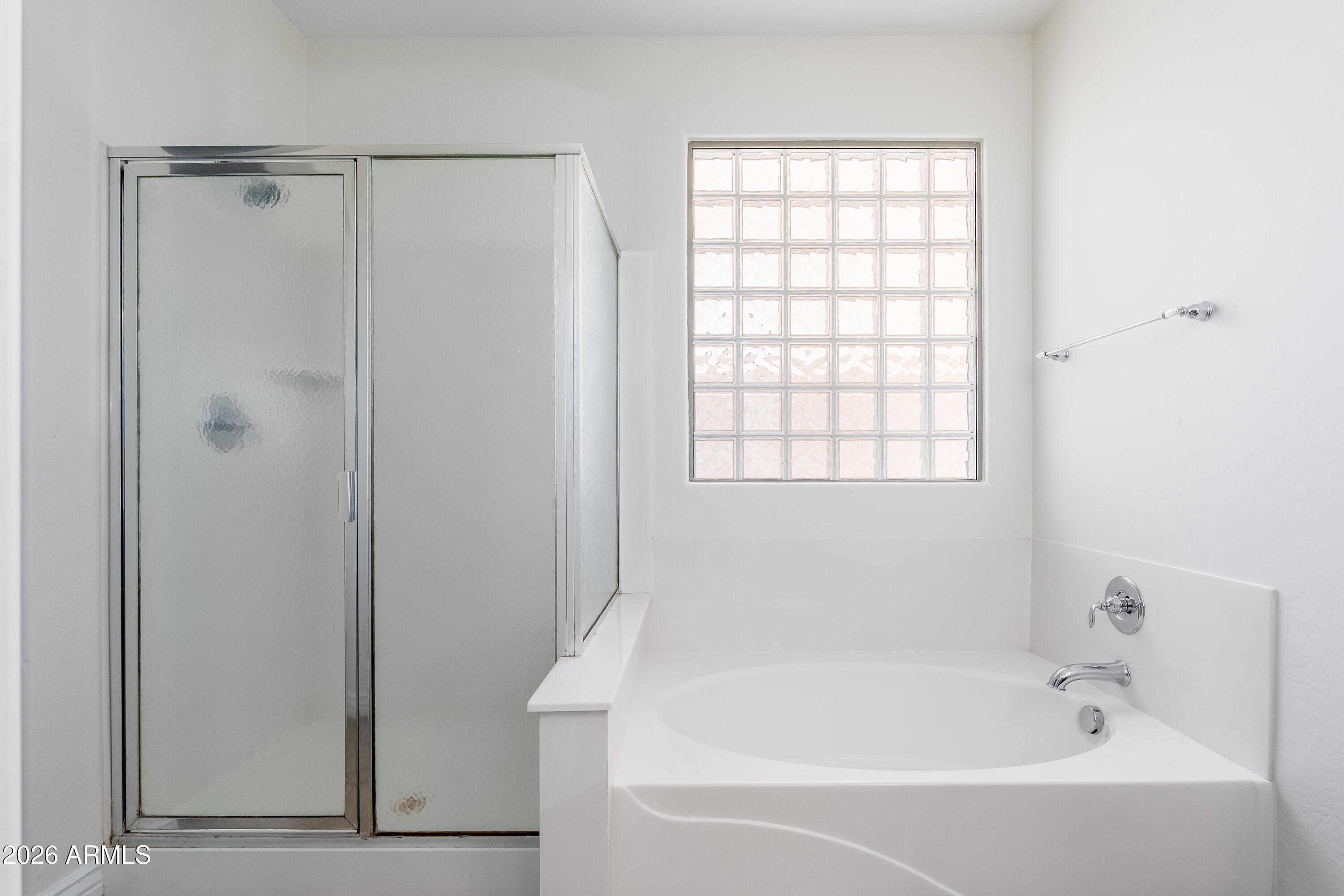 4317 East Folgers Road Phoenix, AZ 85050 - Photo 16 of 40 a white bath tub sitting next to a window