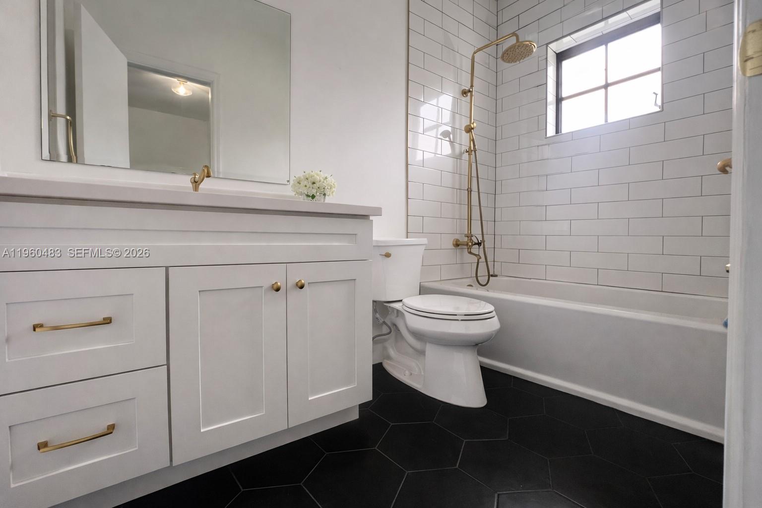 3614 Anderson Road Coral Gables, FL 33134 - Photo 17 of 25 a bathroom with a toilet a sink and bathtub