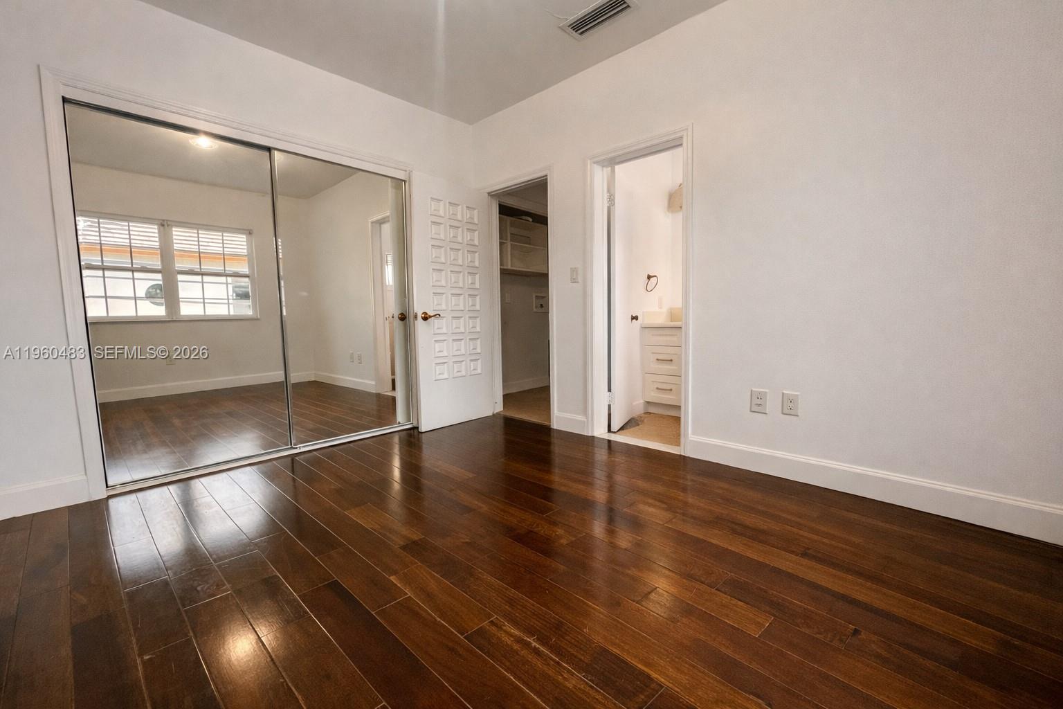 3614 Anderson Road Coral Gables, FL 33134 - Photo 24 of 25 an empty room with wooden floor and windows