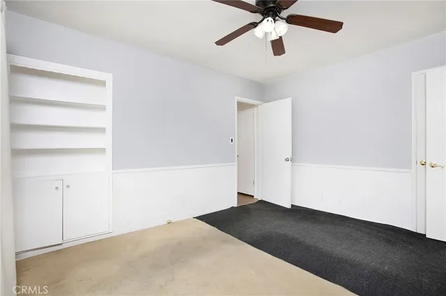 a view of empty room with ceiling fan