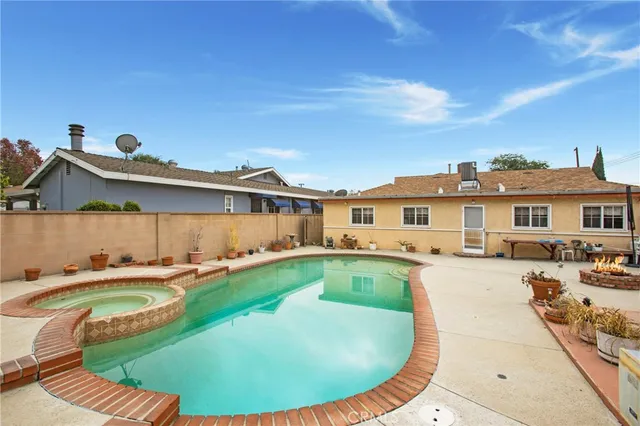 a view of a house with swimming pool and sitting area