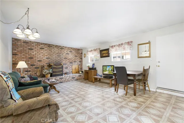 a living room with furniture a dining table and a fireplace