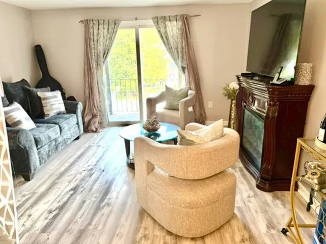 a living room with furniture fireplace and a flat tv screen