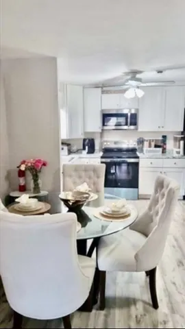 a kitchen with kitchen island granite countertop a sink cabinets and wooden floor