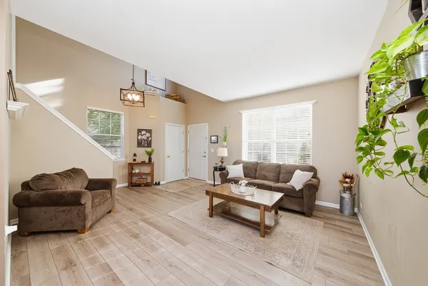 a living room with furniture and a potted plant