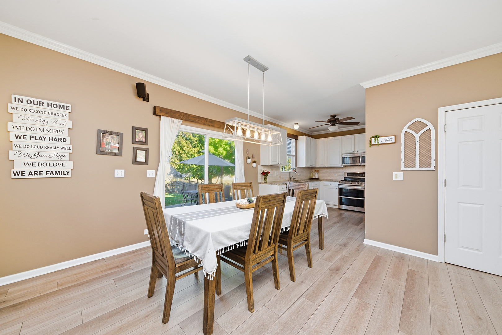 1461 Waterside Drive Bolingbrook, IL 60490 - Photo 6 of 26 a view of a dining room with furniture and wooden floor
