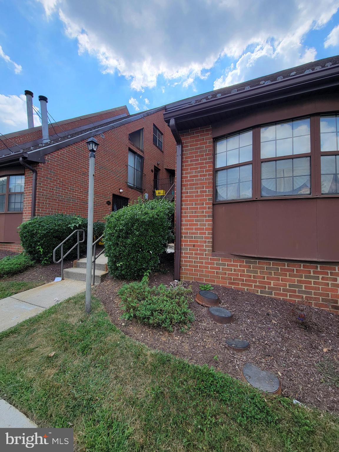 3020 Pineview Court Northeast, Unit 3020 Washington, DC 20018 - Photo 3 of 4 a front view of a house with a yard