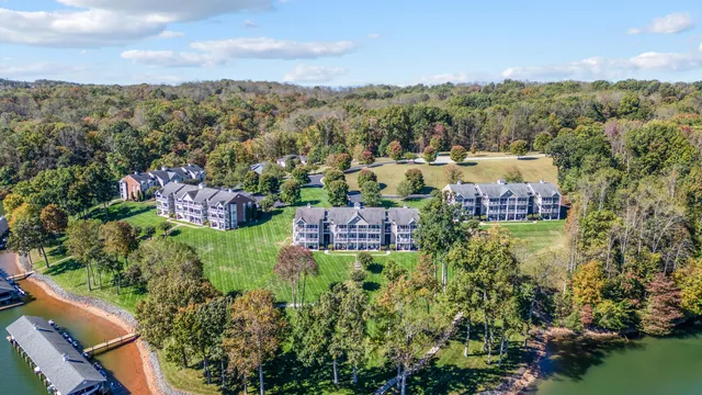 an aerial view of a houses with a lake view