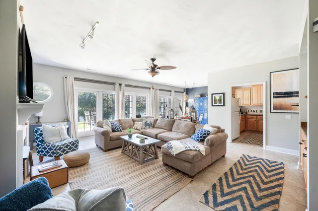a living room with furniture a fireplace and a flat screen tv
