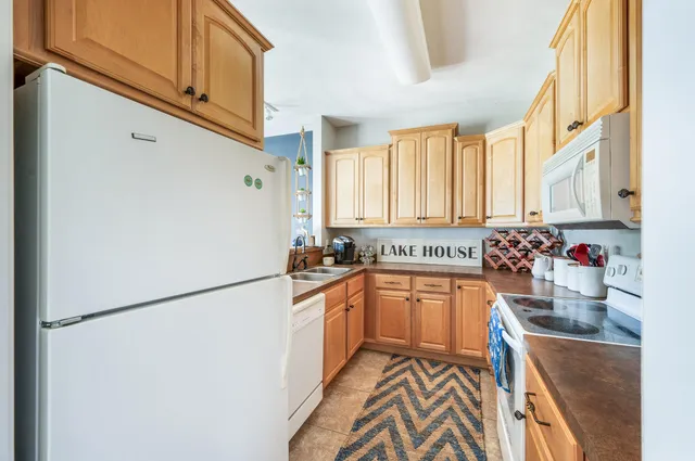 a kitchen with stainless steel appliances granite countertop a sink a stove and a microwave
