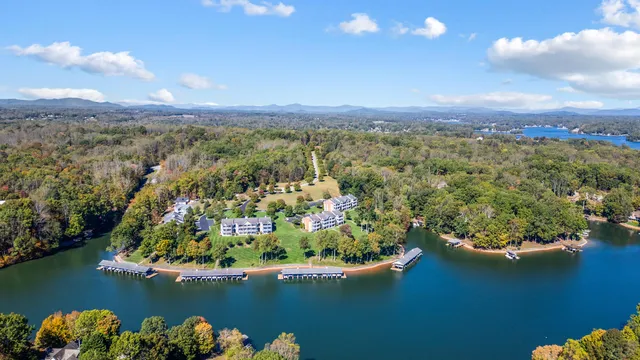 an aerial view of lake and residential houses with outdoor space