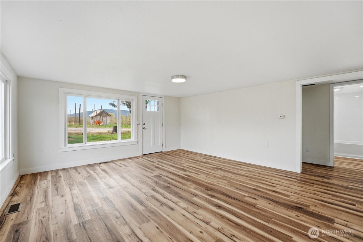 293 Barkley Road Manson, WA 98831 - Photo 3 of 40 wooden floor in an empty room with a window