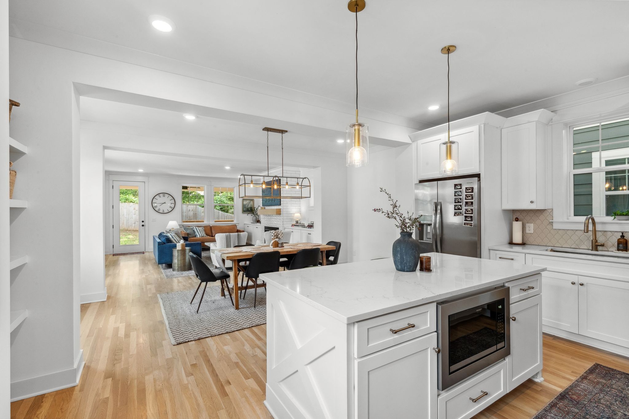 a view of a kitchen area with furniture and wooden floor