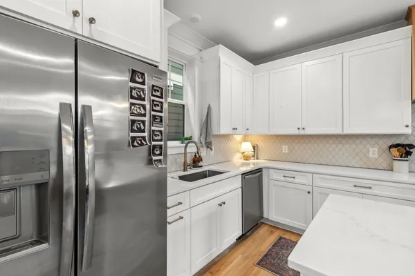 a kitchen with a sink stainless steel appliances and cabinets